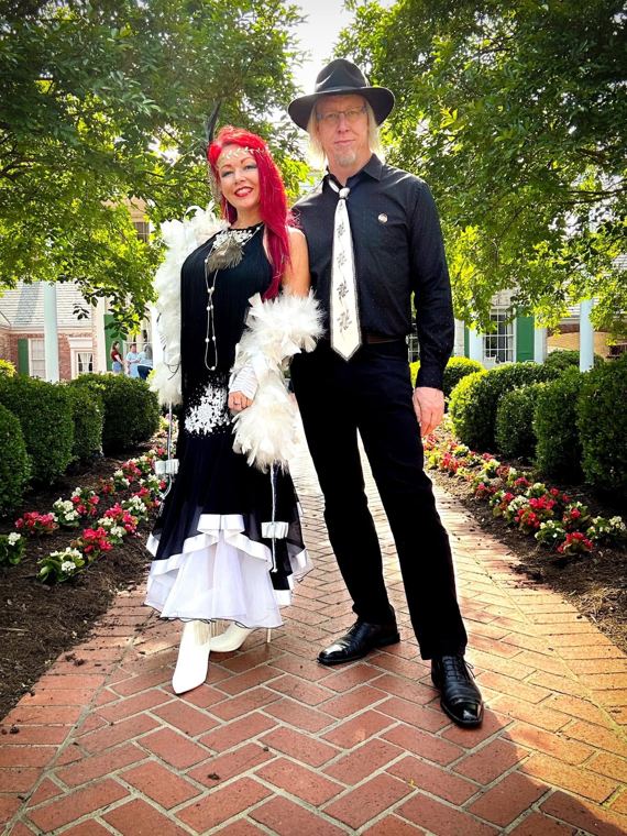 Scott Fray and Madelyn Greco in formal black and white on a garden path