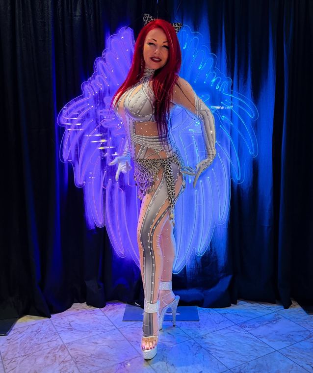 Madelyn Greco in a sequined costume before glowing wings