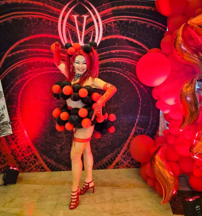 Madelyn Greco in a balloon gown at a red heart backdrop