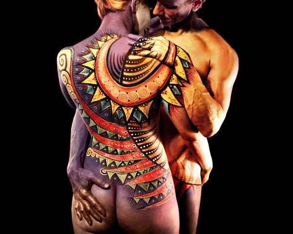 Embracing couple painted as one design in red and gold