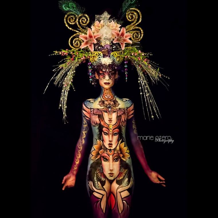 Bodypainted model in a tall floral headdress