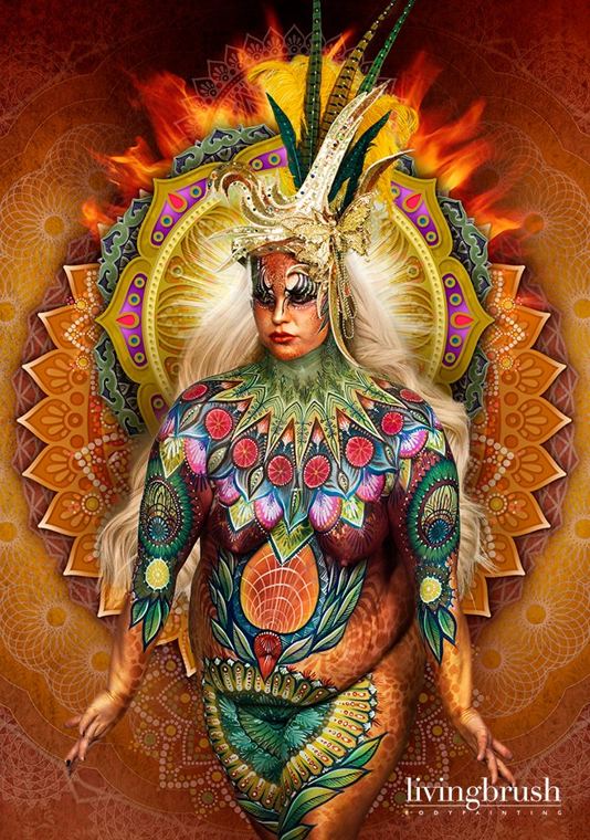 Bodypainting in gold, green and red, finished with a radiant sunburst background
