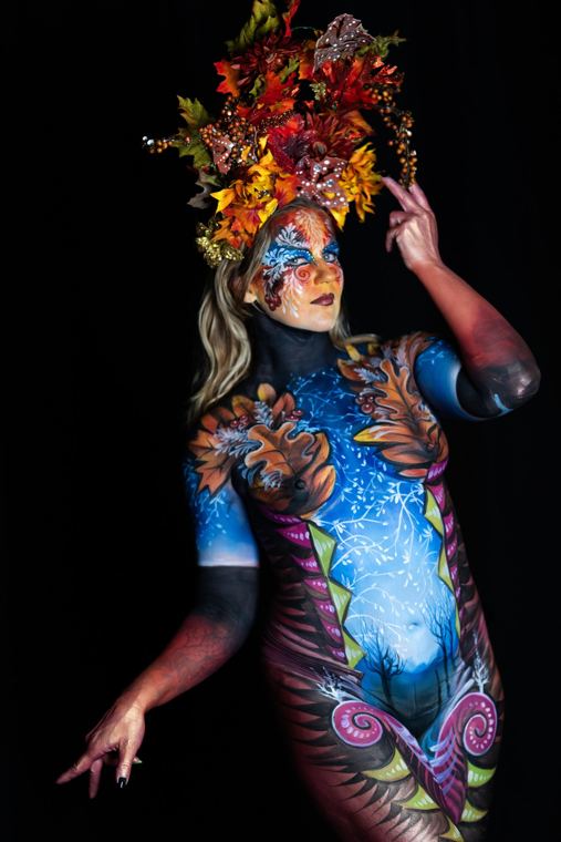 Model bodypainted in blue and copper with an autumn headdress