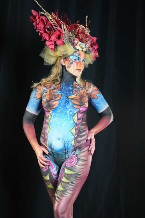Model in a floral headdress and blue body design