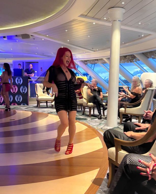Madelyn Greco walking through a ship’s lounge