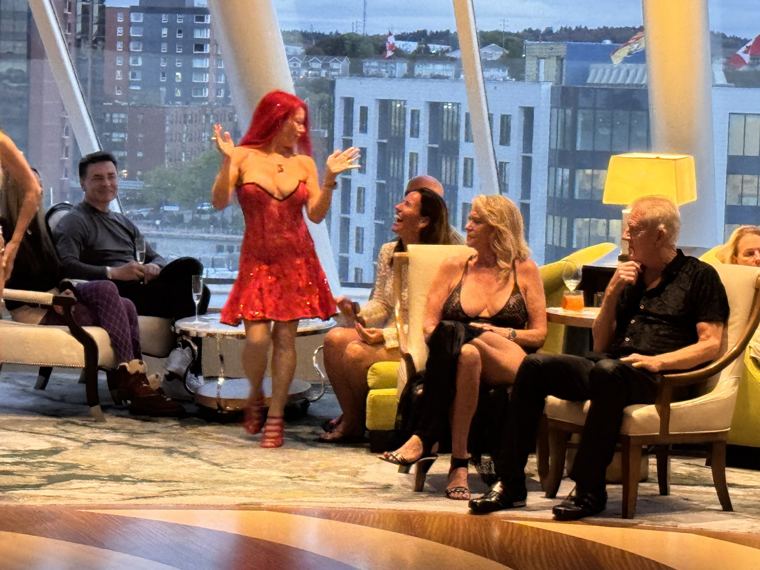 Madelyn Greco hosting in a red dress before guests