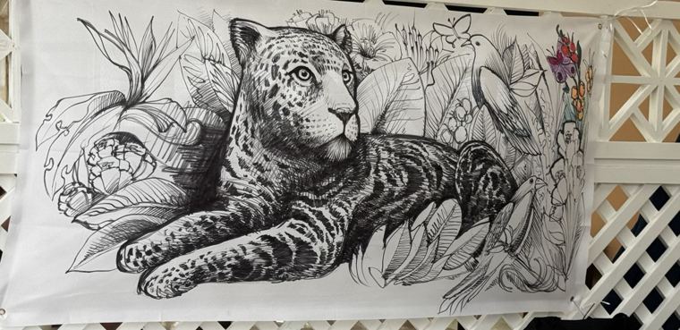 Ink drawing of a jaguar among tropical leaves