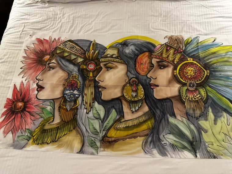 Banner of three women in feathered headdresses