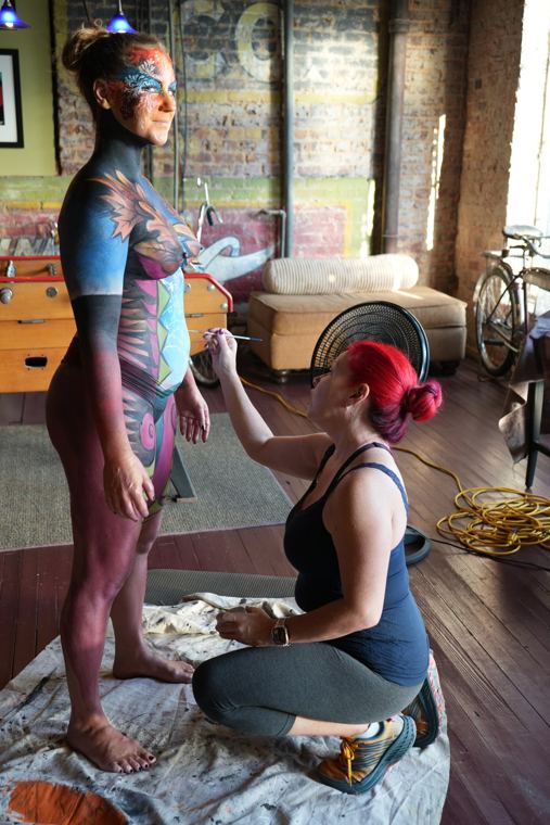 Madelyn Greco painting a model in a studio