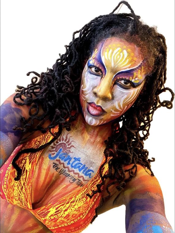 Model with a brand logo painted across her face and shoulders