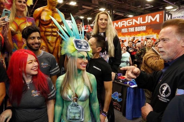 Arnold Schwarzenegger meeting painted models at the Arnold Sports Festival