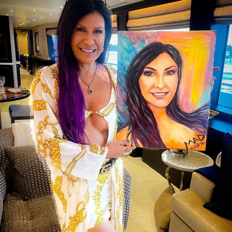 A guest holding her painted portrait aboard a yacht