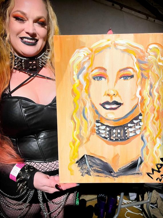 A guest holding her portrait