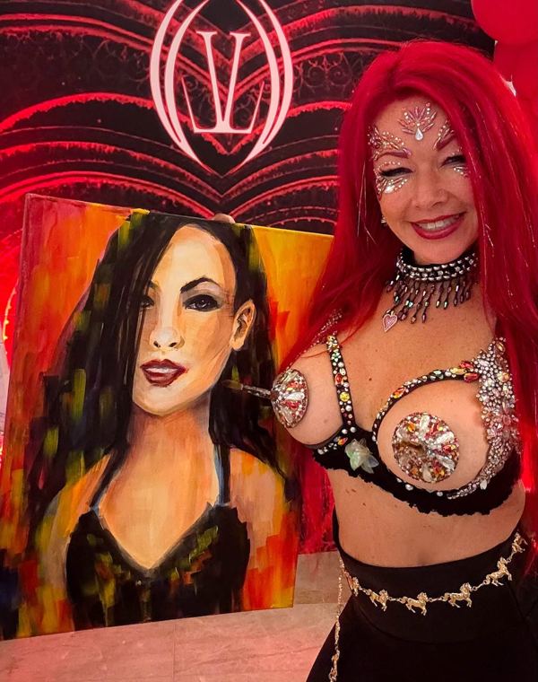 Madelyn Greco beside a finished portrait