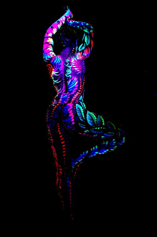 Dancer glowing under black light