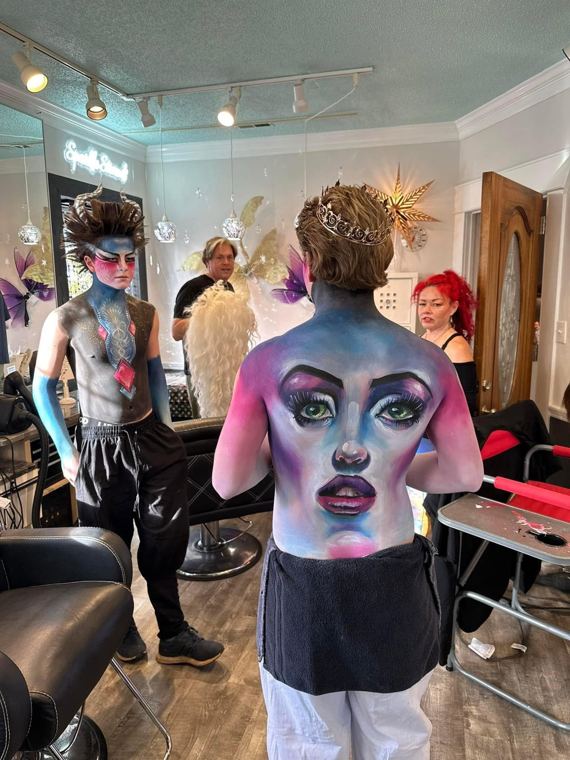 Students painting backs in a studio class