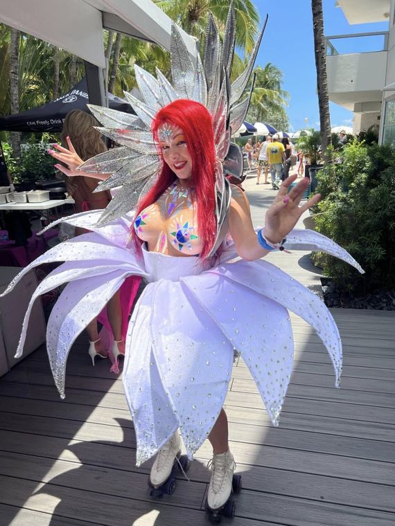 Madelyn Greco on roller skates in a white flower costume, outdoors