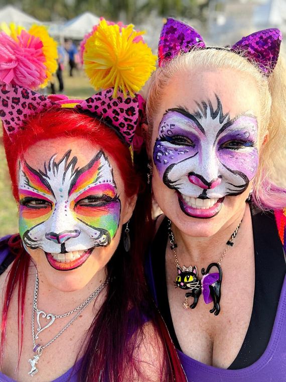 Two guests painted as tigers