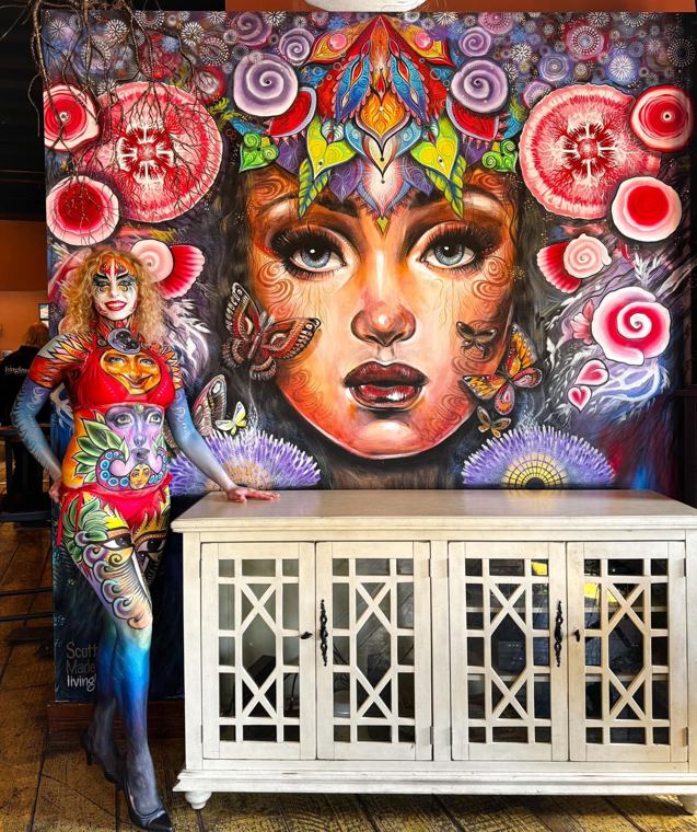 Bodypainted model in front of a large mural
