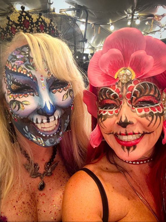 Two guests with skull and floral masks