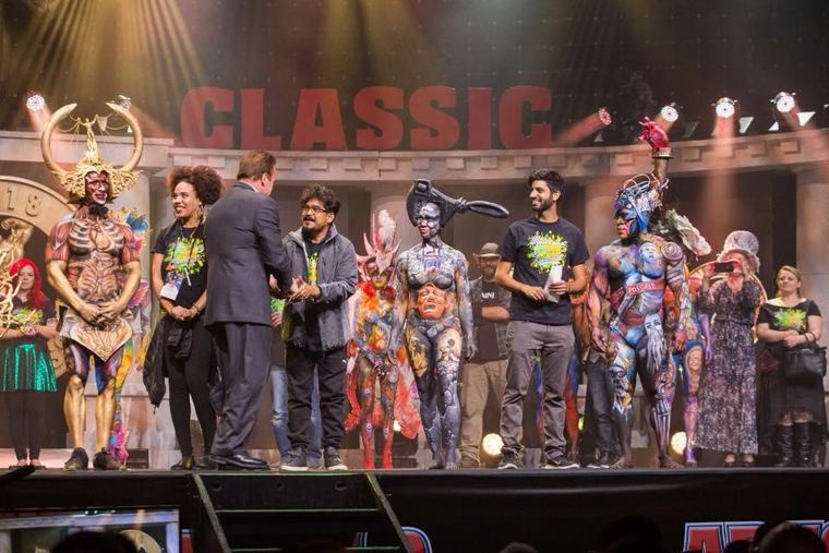 Painted models on stage at the Arnold Classic